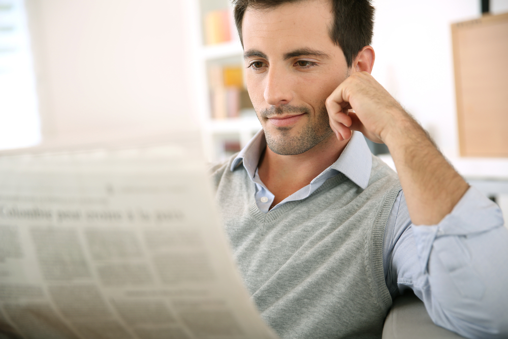 Man at home reading newspaper Man at home reading newspaper
